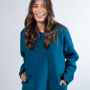 Image of a woman wearing a blue ocean poncho
