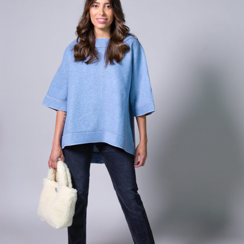 Image of a woman wearing a blue poncho