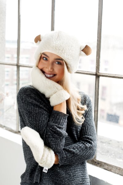 Image of a woman wearing a wollen sheep hat